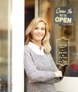 Woman standing outside her business