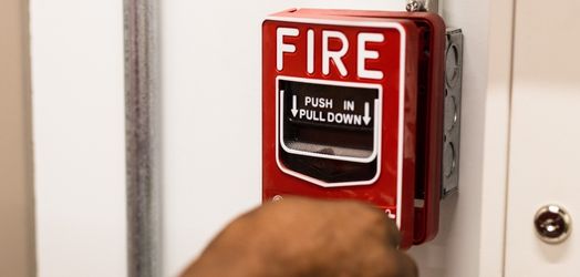 Person unlocking fire pull station