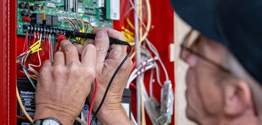 technician working in fire panel