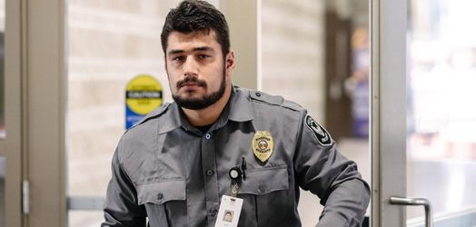 Security guard walking through a door.