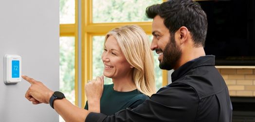 tech and customer at thermostat