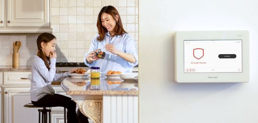 Mother and daughter in kitchen near keypad