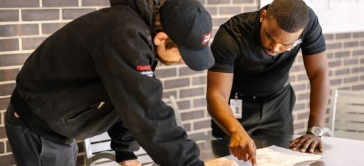 two men looking at a plan