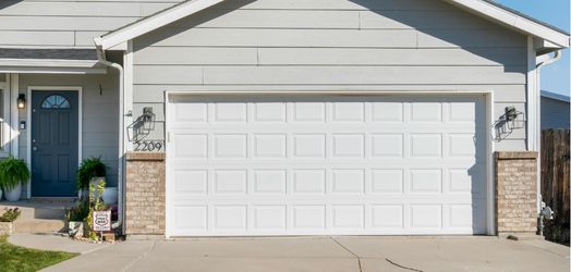 A garage door with Per Mar sign in front
