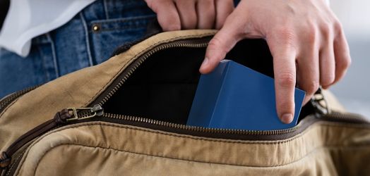Someone putting product in purse