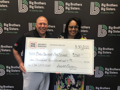 Scott Easter giving check to Big Brothers Big Sisters of Des Moines