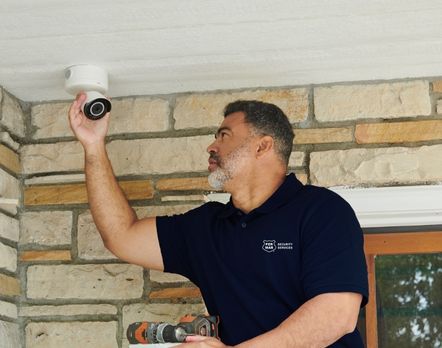 Technician installing security camera