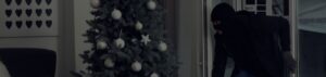 Home burglar next to Christmas tree