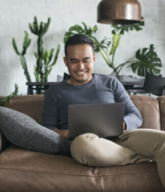 Man sitting on couch with laptop