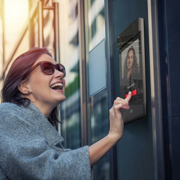 woman interacting with video doorbell